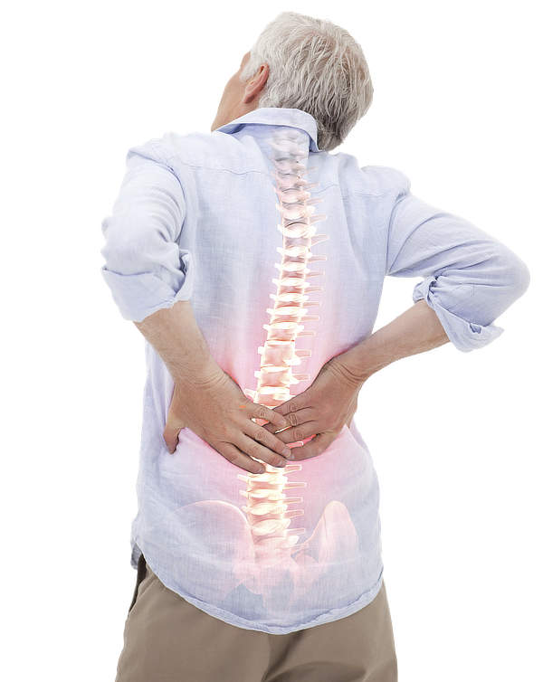 Cheezy stock photography of an older white dude with gray hair, seen from the back, holding his lower back in a posture of significant discomfort. Overlaid on the image is a glowing, semi-transparent illustration of his spine, highlighting the area from the lower back to the mid-spine, which suggests a focus on spinal pain or issues related to the lower back.