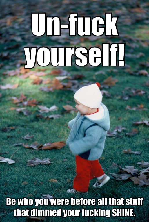 Photograph of a small boy child toddling along adorably on grass with a lot of brown fall leaves scattered around.