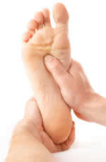 Photograph of a foot being massaged, as a possible treatment for plantar fasciitis.