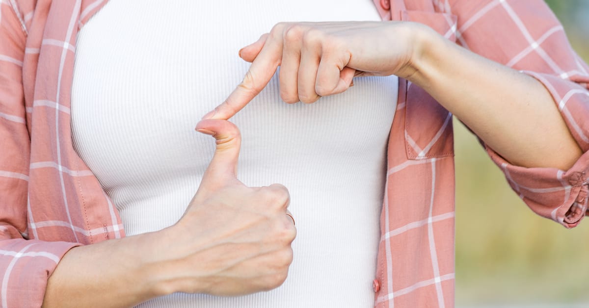 Photo of a woman holding her hands in front of her and dramatically hyperextending the tip of her thumb in a way that makes it look broken, just by pushing on it with the tip of her other index finger.