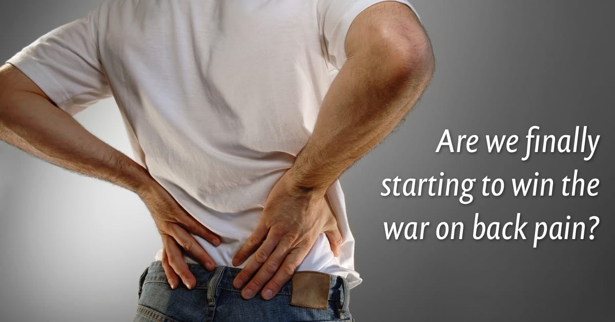 Photo of a man holding his stiff back. There’s a caption reading “Are we finally winning the war on back pain?”