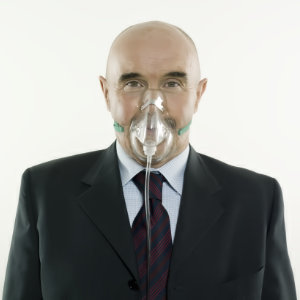 Picture of a man with a respirator, representing difficulty breathing.