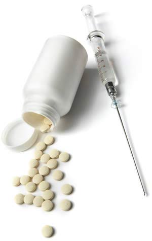 Off-white pills spilling out of an unlabelled white bottle, and a syringe filled with clear fluid.