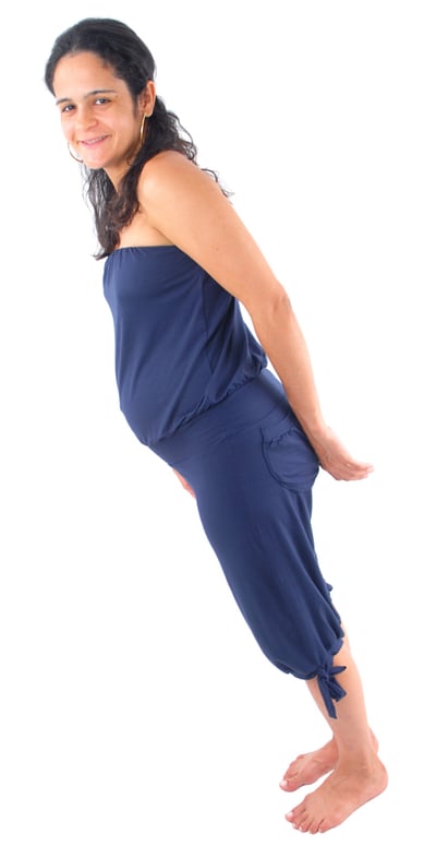 Photo of a pregnant woman, standing. The photo is rotated so that the woman is tilted significantly forward.