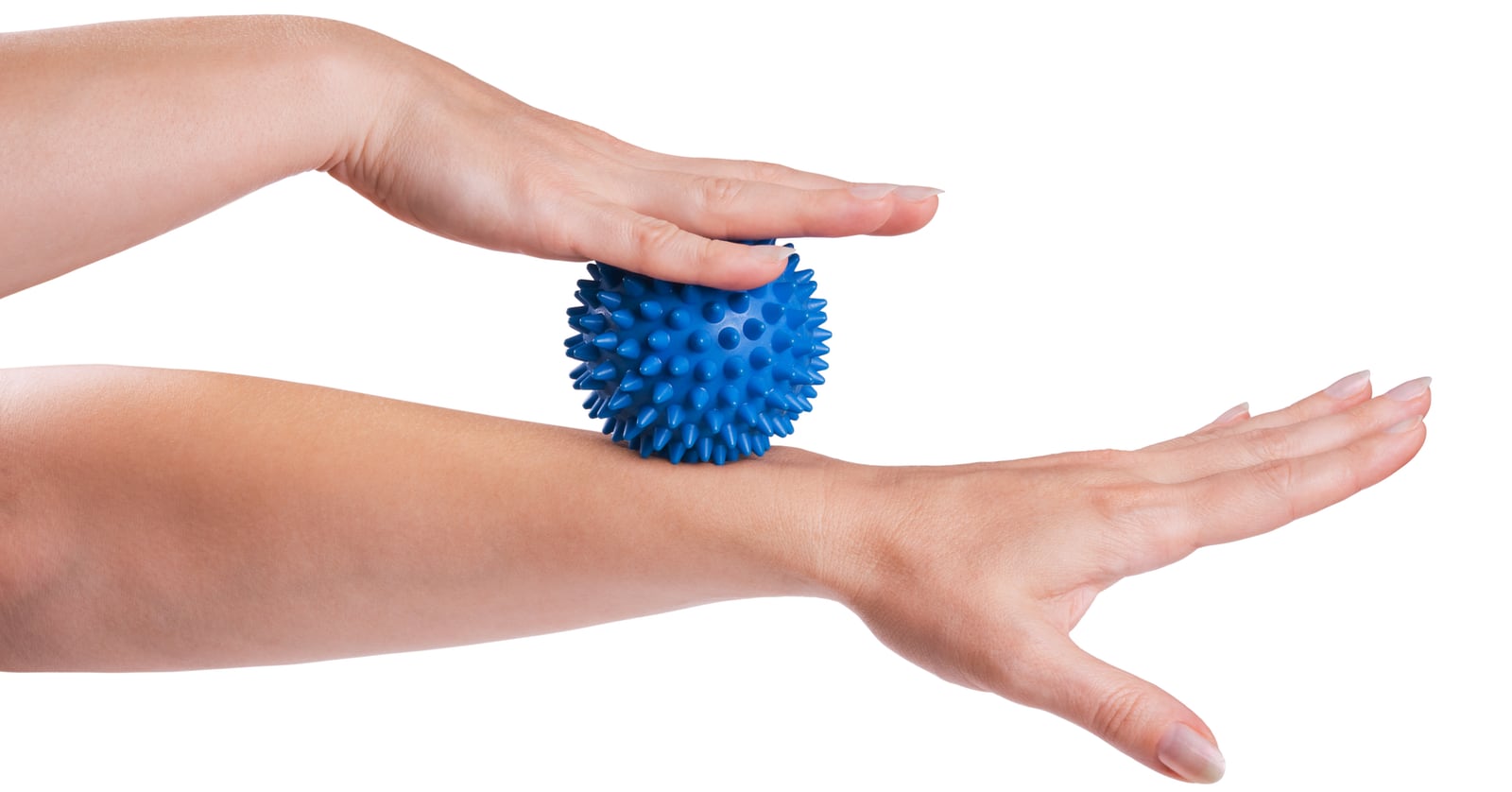 Photo of a woman’s arms, with one hand rolling a massage ball over the other forearm.