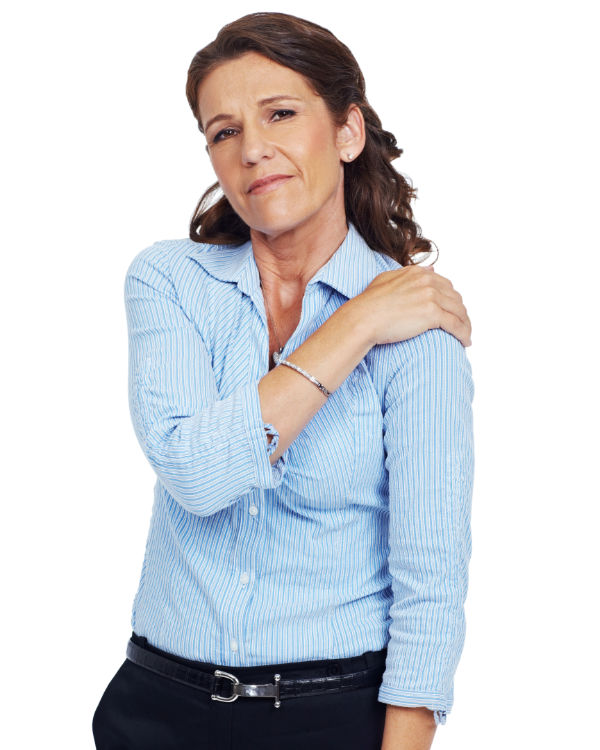 Photo of a woman with frozen shoulder, holding her shoulder, in pain.