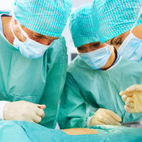 Photo of surgeonss at work on a patient’s spine.