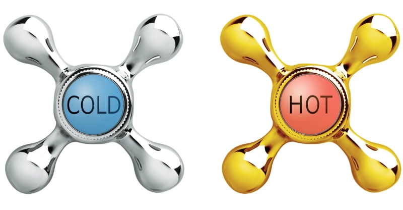 Photograph of vintage water faucets labelled hot and cold, representing cryotherapy and thermotherapy.